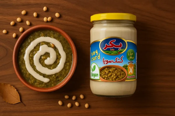 کشک سویا بکر کنار ظرف آش ایرانی با تزئین کشک روی میز چوبی نارون